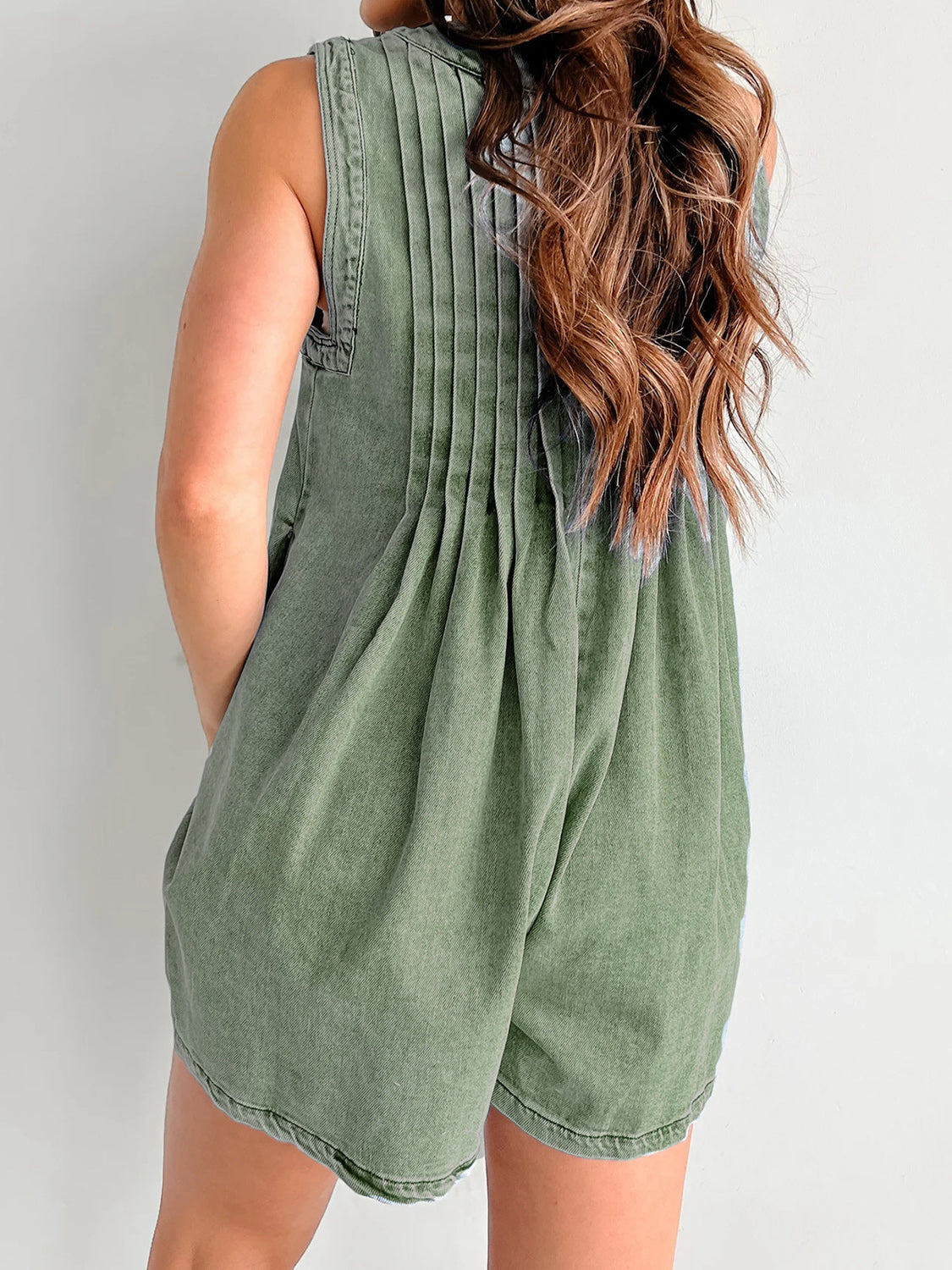 Moss green denim playsuit with back pleats and A-line shorts.