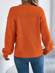 Orange acrylic chevron knit sweater with balloon sleeves and ribbed trim.