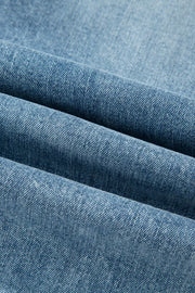 Distressed denim flare jeans in a light blue wash, showing fabric texture.