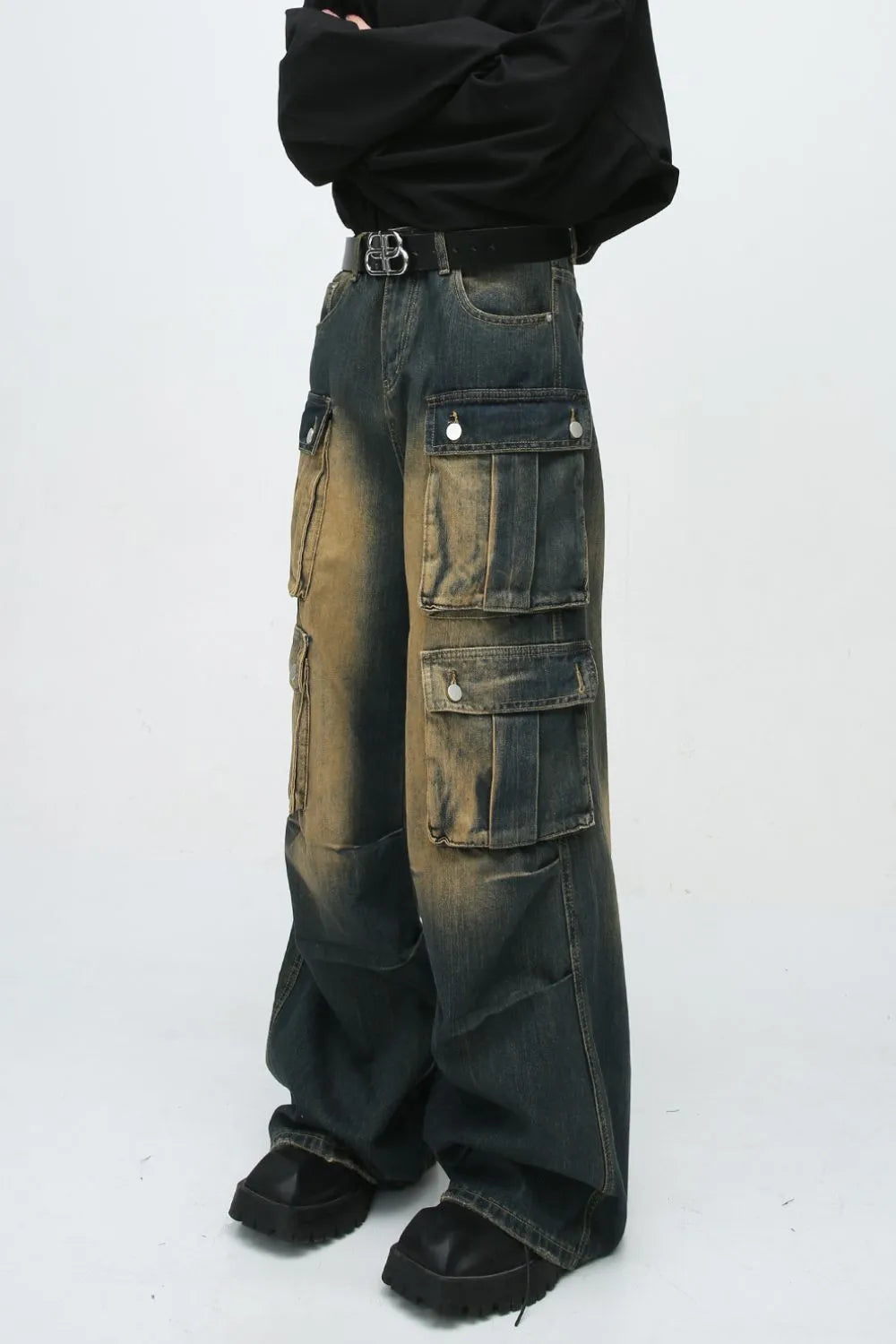 Faded wash oversized cargo jeans in dark blue denim with multiple button flap pockets and a baggy fit.