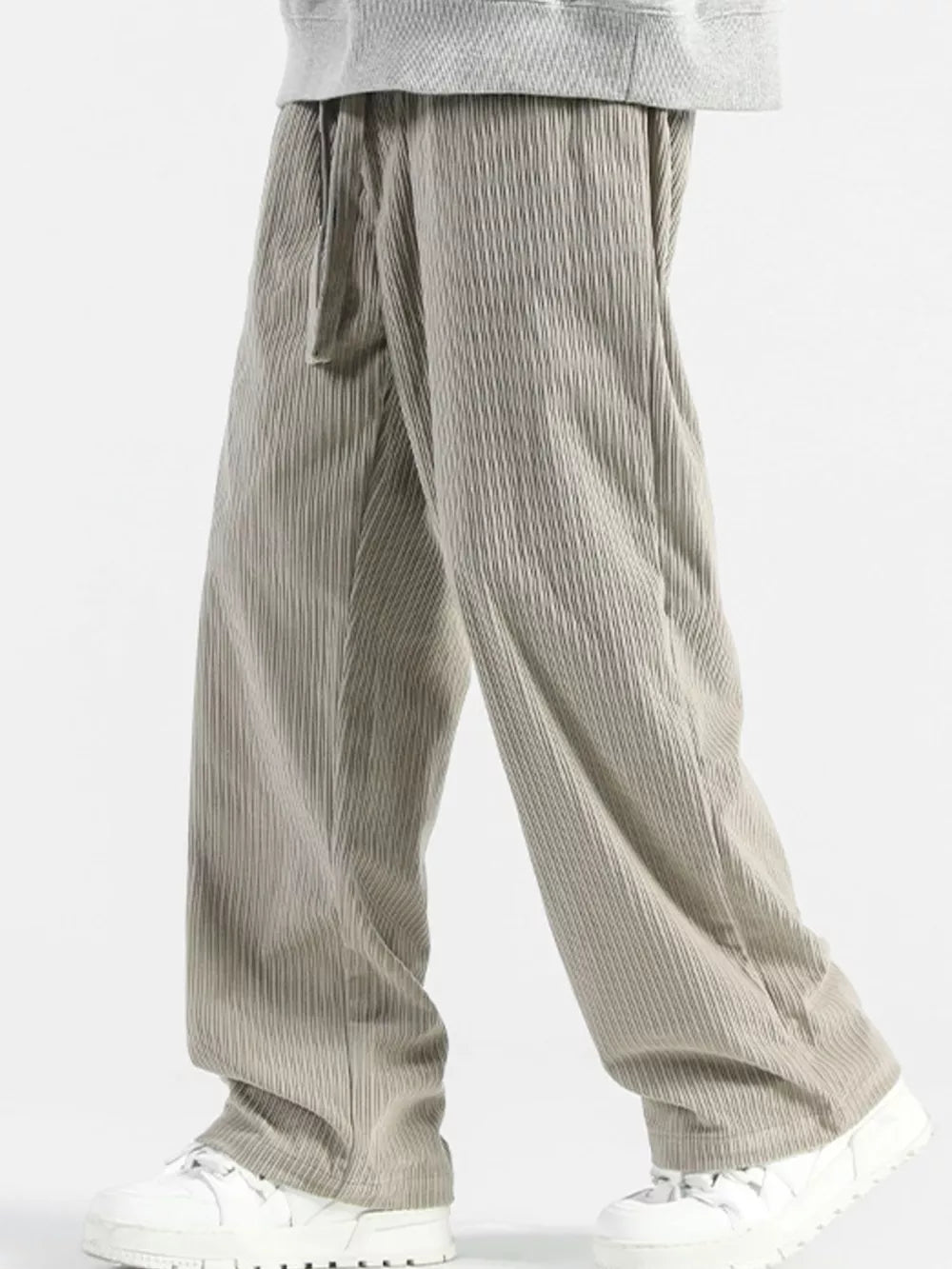 Men's gray wide-leg sweatpants with vertical texture and drawstring waist.