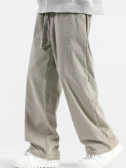 Men's gray wide-leg sweatpants with vertical texture and drawstring waist.