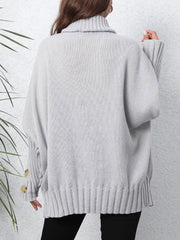 Light gray turtleneck sweater with button cuffs and ribbed hem.