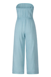 Light blue bandeau jumpsuit with smocked bodice and wide-leg pants.