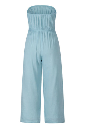 Light blue bandeau jumpsuit with smocked bodice and wide-leg pants.