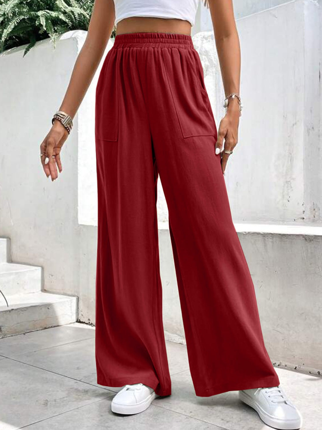 Burgundy relaxed drape palazzo trousers with pockets and elastic waist.