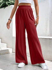 Burgundy relaxed drape palazzo trousers with pockets and elastic waist.