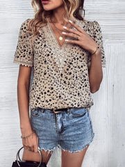 Floral lace trim v-neck blouse in tan with black floral print, short sleeves.