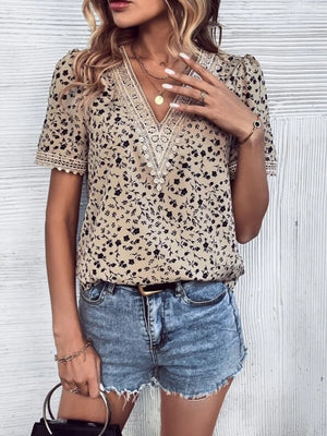 Floral lace trim v-neck blouse in tan with black floral print, short sleeves.