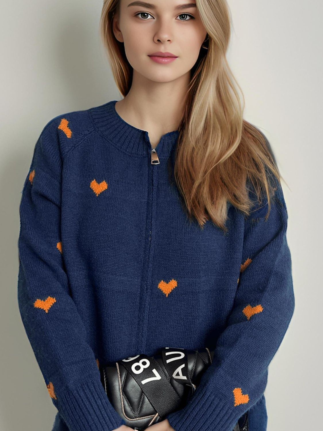 Dark blue zip-through knit cardigan with allover orange heart print, acrylic.