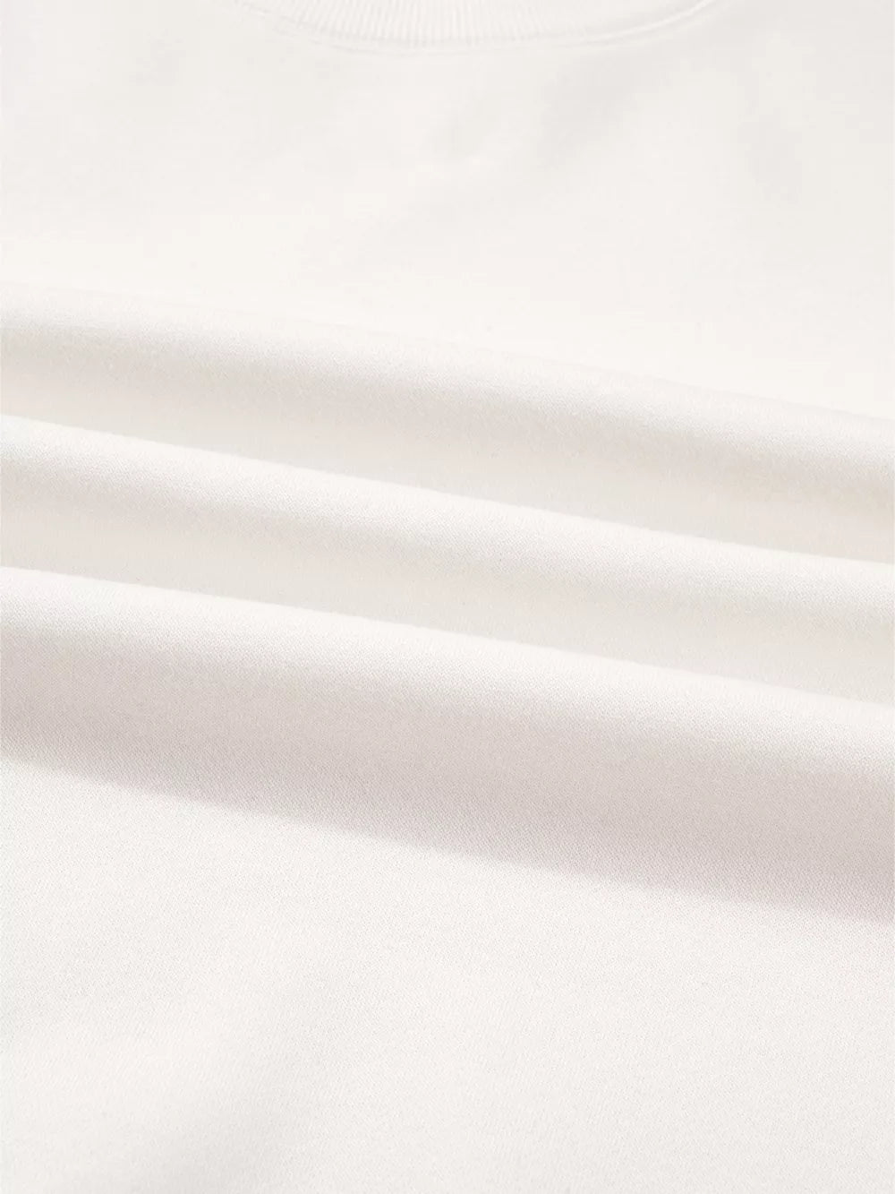 White cotton pullover fabric detail, soft and comfortable loungewear material.