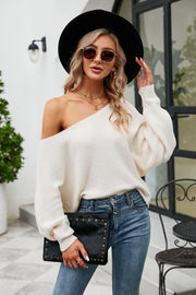 White off-shoulder ribbed knit sweater with balloon sleeves and boat neck.