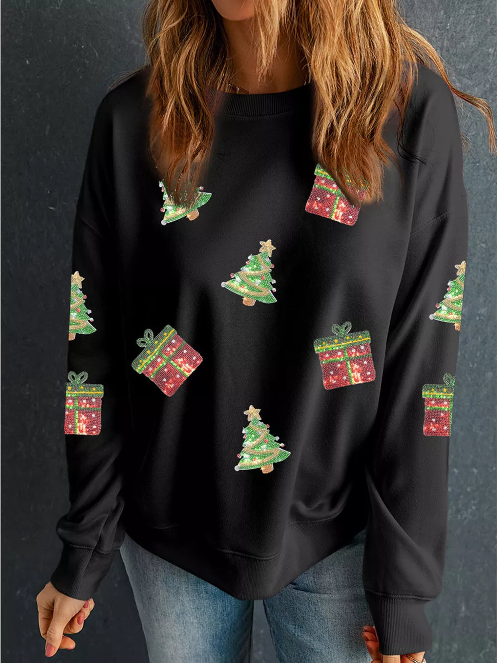 Black crew neck sweatshirt with festive sequin Christmas tree and gift pattern.