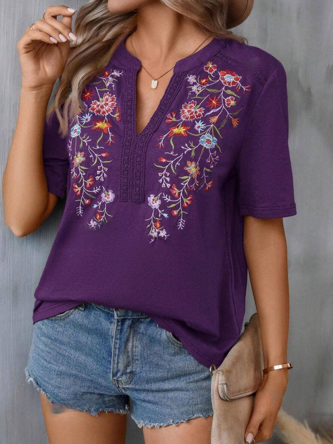 Violet embroidered v-neck tee with crochet trim and short sleeves.