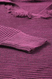 Burgundy textured knit pullover sweater with fringe trim and ribbed cuff detail.