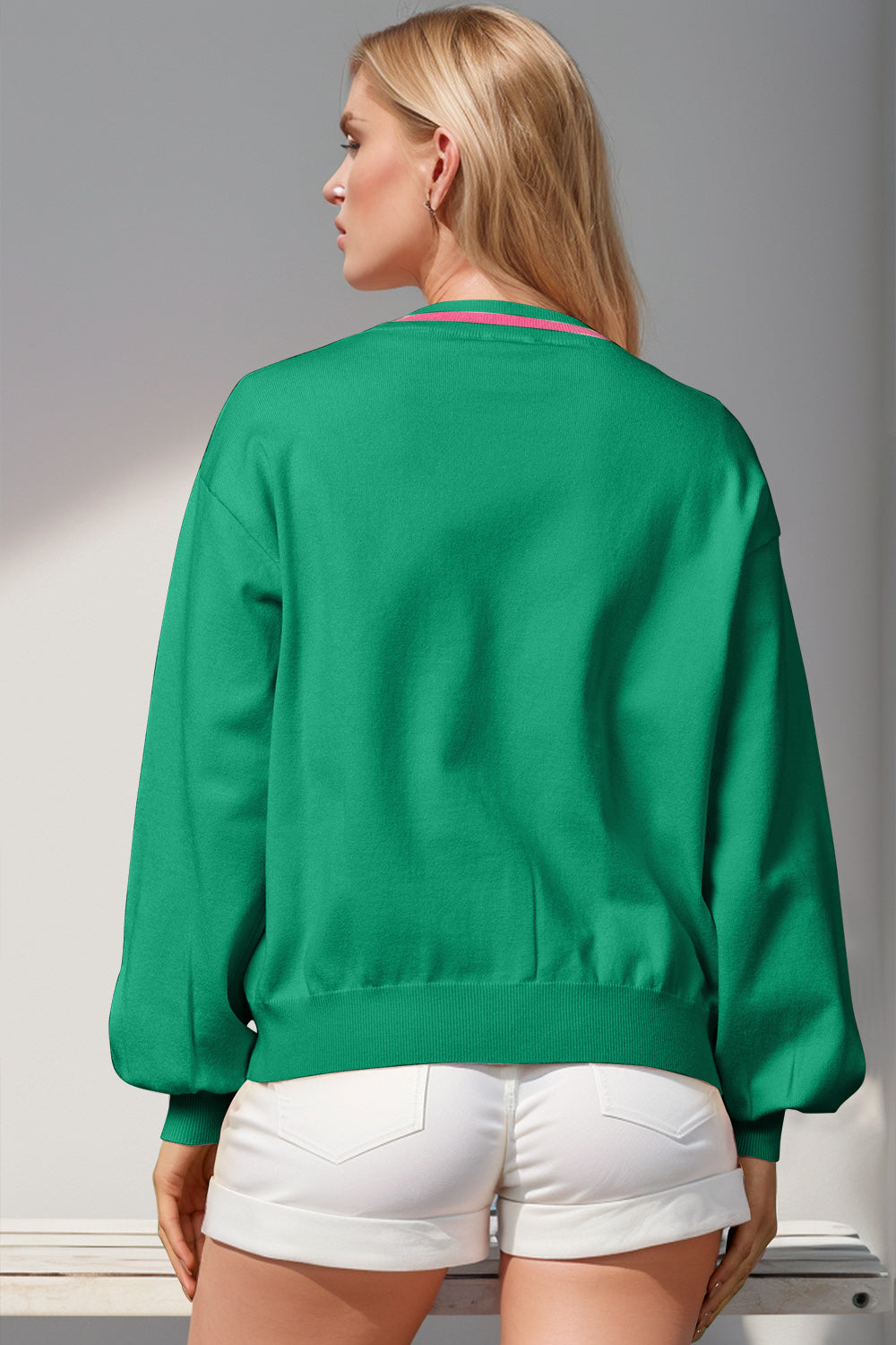 Green acrylic cardigan with pink striped neckline and balloon sleeves