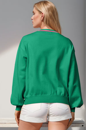 Green acrylic cardigan with pink striped neckline and balloon sleeves