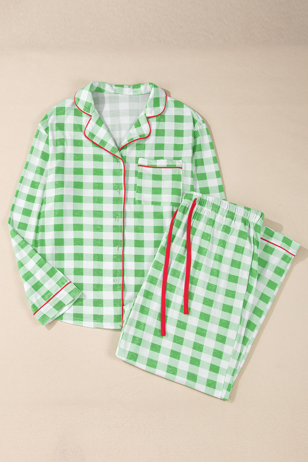 Light green gingham pajama set with red trim, collared long sleeve top and drawstring pants.