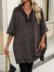 Asymmetrical knit zip-neck poncho in coffee brown with a textured marled knit and short sleeves.