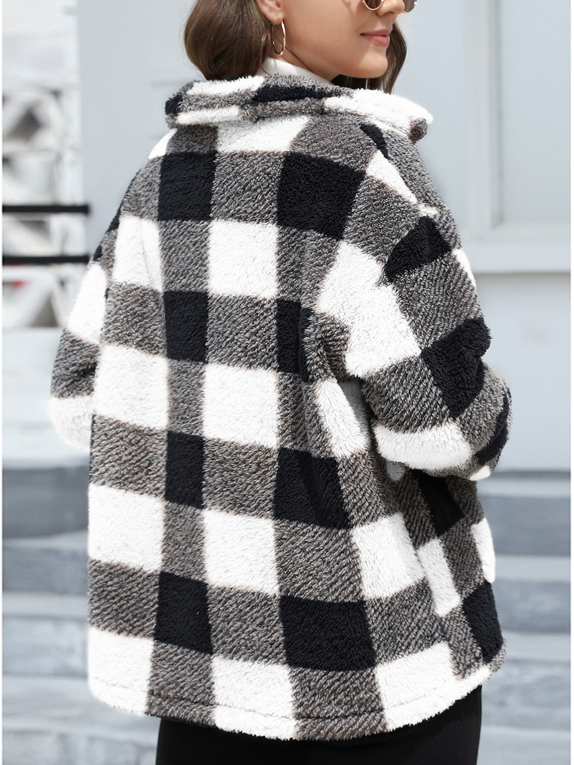 Plaid sherpa overshirt jacket in black and white buffalo check with a fuzzy texture.