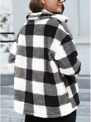 Plaid sherpa overshirt jacket in black and white buffalo check with a fuzzy texture.