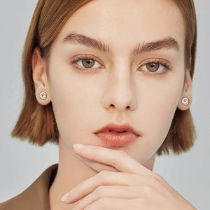 Gold bezel-set crystal stud earrings with a bright D color grade stone.