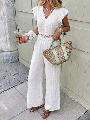 White lace-trimmed wide-leg romper with flutter sleeves and cutout waist detail
