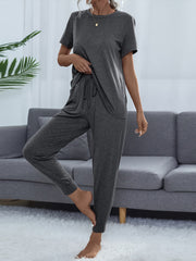 Charcoal relaxed-fit tee and joggers with drawstring waist and cuffed ankles.