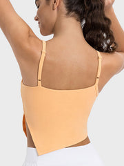 Sherbet cami top with asymmetric cutout hem and adjustable straps.