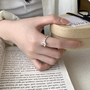 Sleek geometric zircon silver ring with a twisted band.
