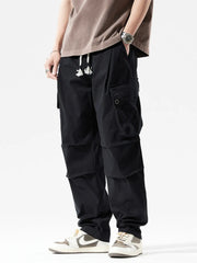 Men's black cargo sweatpants with drawstring and multiple pockets.