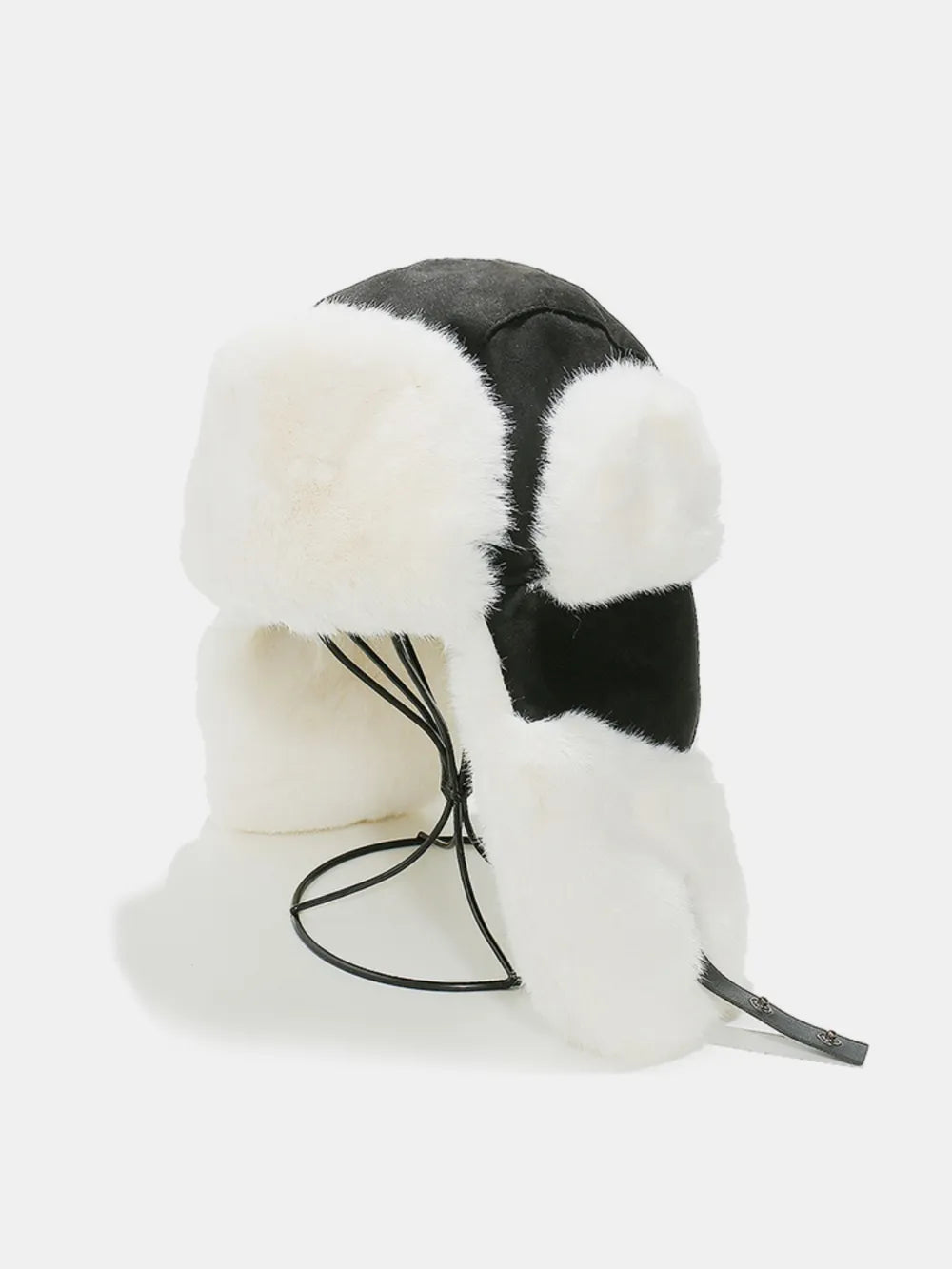 Black and white shearling aviator trapper hat with faux fur trim and ear flaps.