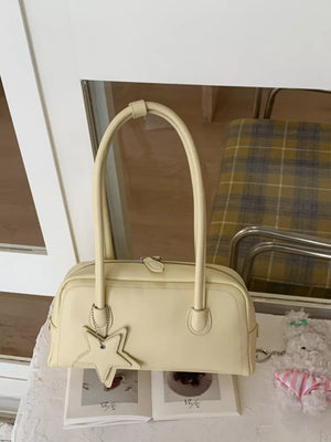 Yellow shoulder bag with star charm and top handles