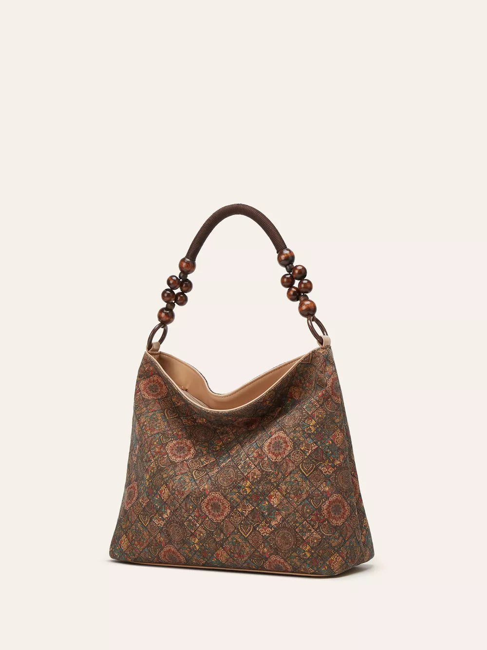 Vibrant bohemian hobo tote in brown with geometric pattern and beaded strap.