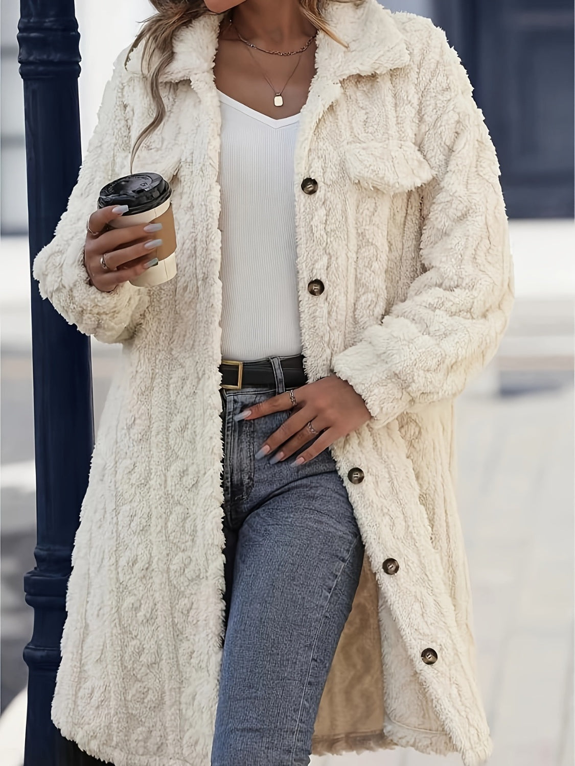 Cream textured shacket-coat with patch pockets and button front, worn open over a white top and jeans.