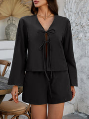 Black linen tie-front top and shorts set with flared sleeves.