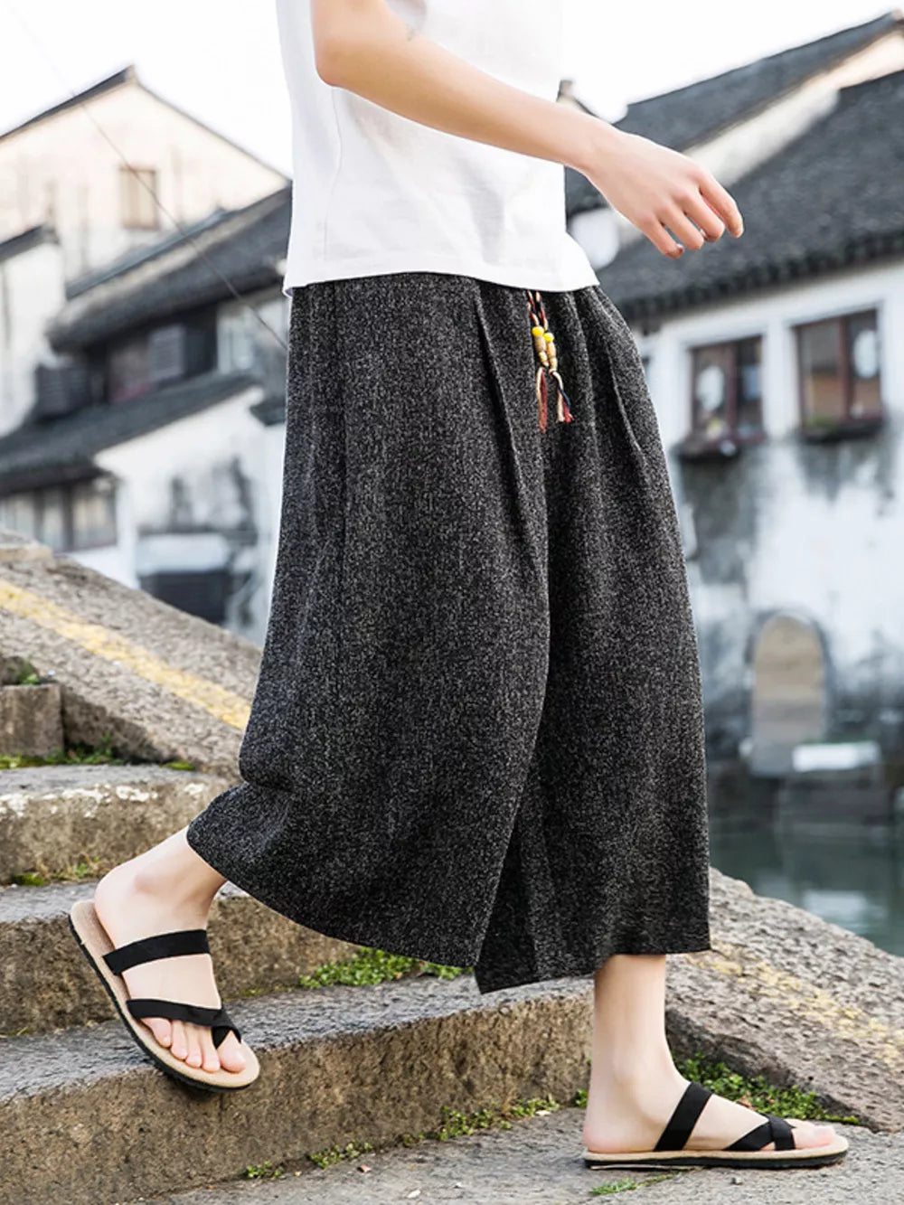 Gray relaxed fit wide-leg cropped cargo pants with drawstring detail and beaded tassel.