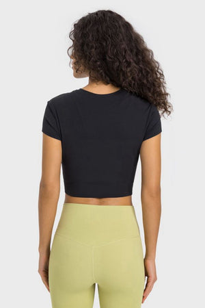 Black ribbed crewneck crop top with short sleeves.