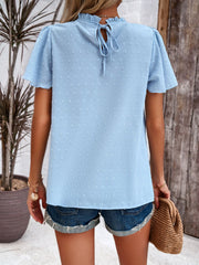 Light blue dotted swiss smocked bodice flutter sleeve top with tie back
