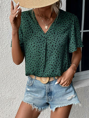 Emerald leopard print V-neck blouse with short flutter sleeves.