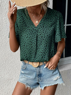Emerald leopard print V-neck blouse with short flutter sleeves.