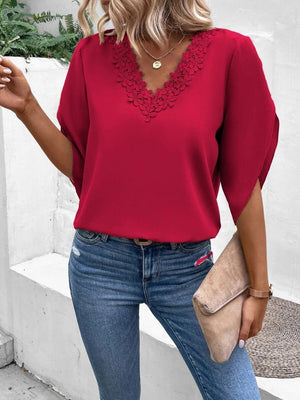 Deep red flutter sleeve blouse with scalloped lace trim neckline.