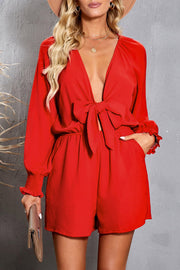 Scarlett tie-front blouson sleeve playsuit with ruffled cuffs and a deep V-neck.