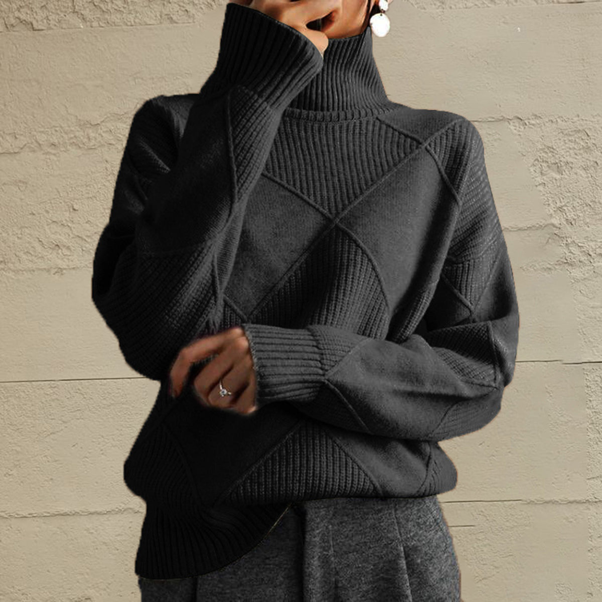 Black turtleneck sweater with diamond knit pattern and ribbed details.
