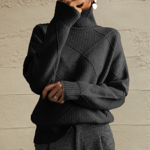 Black turtleneck sweater with diamond knit pattern and ribbed details.