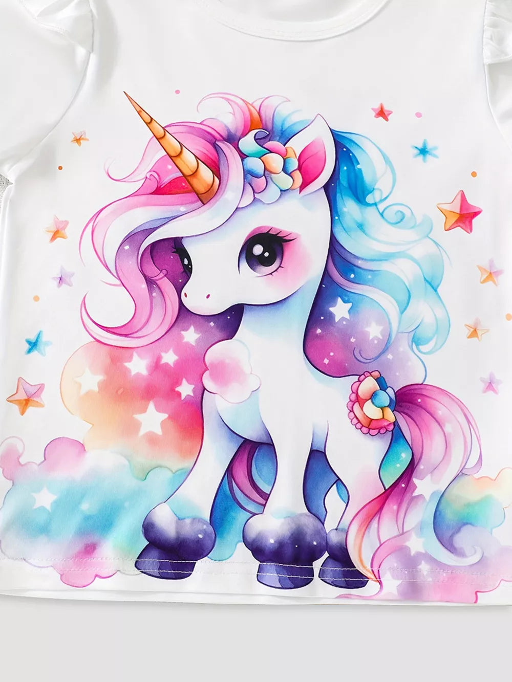 White cotton baby set with a watercolor unicorn print and ruffle sleeves.