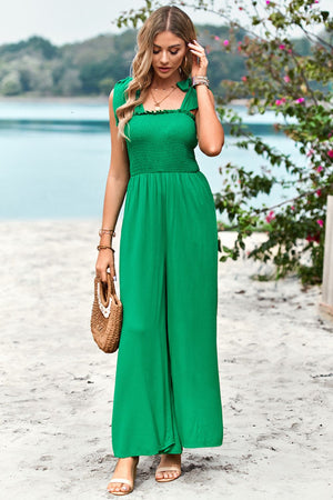 Green smocked bodice tie-strap palazzo jumpsuit with wide legs.