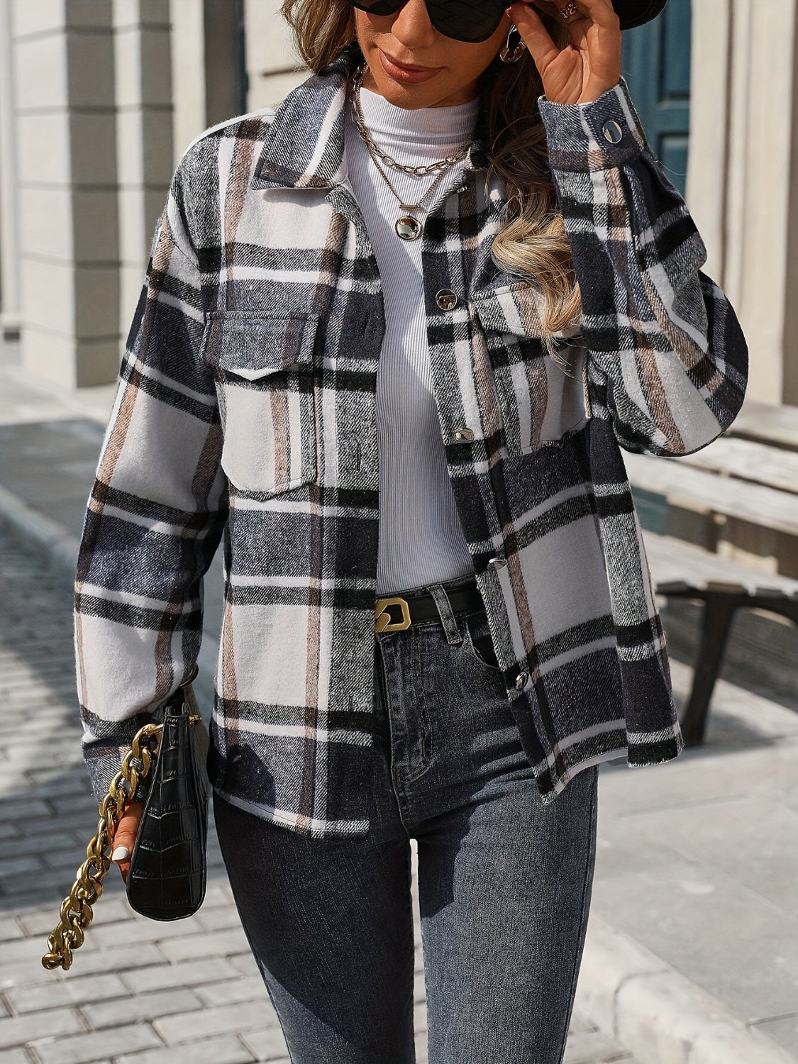 Black plaid overshirt with patch pockets and button front, styled with jeans.