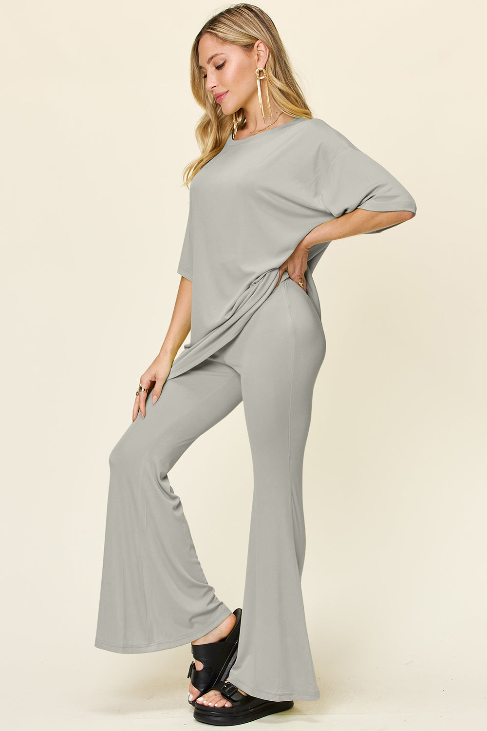 Light gray oversized tee and flare leg pants set with crew neck and short sleeves.