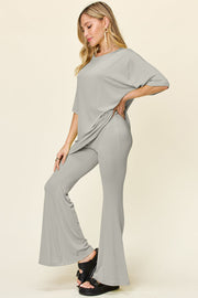 Light gray oversized tee and flare leg pants set with crew neck and short sleeves.